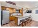 Basement kitchenette area with new cabinetry, bar seating and stainless appliances at 250 W Midway Blvd, Broomfield, CO 80020
