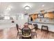Finished basement featuring a cozy dining area with a round wooden table and a bar area with stone backsplash at 250 W Midway Blvd, Broomfield, CO 80020
