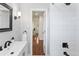 Renovated bathroom with white subway tile, a vanity, and black hardware fixtures at 250 W Midway Blvd, Broomfield, CO 80020
