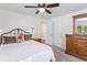 Spacious bedroom featuring neutral walls, wood furniture and a decorative mirror at 250 W Midway Blvd, Broomfield, CO 80020