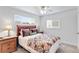 Comfortable bedroom with a decorative quilt, wood furniture and lots of natural light at 250 W Midway Blvd, Broomfield, CO 80020
