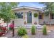 Close up front entrance with beautifully landscaped small trees and healthy flowering garden at 250 W Midway Blvd, Broomfield, CO 80020
