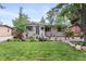 Charming single-story home with a lush, well-manicured front yard and mature trees at 250 W Midway Blvd, Broomfield, CO 80020