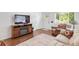 Comfortable living room featuring wood floors, a cozy armchair, and a classic area rug at 250 W Midway Blvd, Broomfield, CO 80020