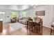 Open concept living room with plenty of natural light and wood floors next to dining area at 250 W Midway Blvd, Broomfield, CO 80020