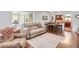 Inviting living room features wood floors, neutral color palette, and lots of natural light at 250 W Midway Blvd, Broomfield, CO 80020