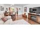 Open concept living room with dining area and living room featuring wood floors and neutral colors at 250 W Midway Blvd, Broomfield, CO 80020
