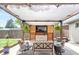 Outdoor patio features a pergola, a TV, outdoor seating, and decorative plants for relaxing entertainment at 250 W Midway Blvd, Broomfield, CO 80020