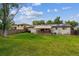 Large backyard featuring mature trees and a privacy fence, offering a peaceful retreat at 6508 S Garland Way, Littleton, CO 80123