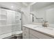 Bright and modern bathroom with walk-in shower and quartz countertops on vanity at 6508 S Garland Way, Littleton, CO 80123