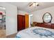 Cozy bedroom with neutral carpet, wardrobe, dresser, and a view to another bedroom at 6508 S Garland Way, Littleton, CO 80123