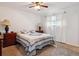Bright bedroom with neutral carpet, ceiling fan, and a cozy window with sheer curtains at 6508 S Garland Way, Littleton, CO 80123