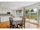 Eat-in kitchen features a sliding glass door to the backyard patio and outdoor dining space at 6508 S Garland Way, Littleton, CO 80123