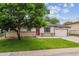Charming ranch-style home featuring a cozy front porch, well-maintained lawn, and attached garage at 6508 S Garland Way, Littleton, CO 80123