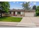 Charming ranch-style home featuring a cozy front porch, well-maintained lawn, and attached garage at 6508 S Garland Way, Littleton, CO 80123