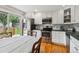 Bright eat-in kitchen features stainless steel appliances and access to the backyard patio at 6508 S Garland Way, Littleton, CO 80123
