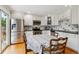 Bright eat-in kitchen features stainless steel appliances and plenty of cabinets for storage at 6508 S Garland Way, Littleton, CO 80123
