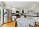 Eat-in kitchen features stainless steel appliances, white cabinetry, and stylish backsplash at 6508 S Garland Way, Littleton, CO 80123