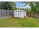 Outdoor shed providing ample storage space, nestled in a green, grassy backyard at 6508 S Garland Way, Littleton, CO 80123