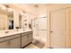 Bathroom featuring double sinks, granite countertops, a glass shower, and natural light at 1005 Ryland Rd, Brighton, CO 80603