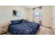Comfortable bedroom featuring plush carpet, a double window, and modern decor at 1005 Ryland Rd, Brighton, CO 80603