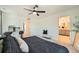 Bright primary bedroom showcasing ensuite bathroom, a large window, and a comfortable bed with luxurious bedding at 1005 Ryland Rd, Brighton, CO 80603
