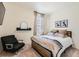 Cozy bedroom with plush carpet, a comfortable bed with stylish linens, and natural light from the window at 1005 Ryland Rd, Brighton, CO 80603