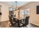 Elegant dining room with hardwood floors, a modern light fixture, and sliding doors to the outdoor patio at 1005 Ryland Rd, Brighton, CO 80603