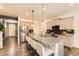 Modern kitchen with an island, stainless steel appliances, granite countertops, and barstool seating at 1005 Ryland Rd, Brighton, CO 80603
