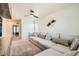 Spacious living room with a large grey sectional, a ceiling fan, and stylish wall decor at 1005 Ryland Rd, Brighton, CO 80603