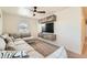 Cozy living room with a large sectional sofa, mounted TV, and modern shelving for storage at 1005 Ryland Rd, Brighton, CO 80603