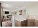 Finished basement area offering a kitchenette and entertainment area with vinyl floors at 11980 Swansea Dr, Parker, CO 80134