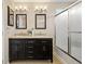Bathroom features a double vanity with granite countertop and a glass-enclosed shower at 11980 Swansea Dr, Parker, CO 80134