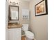 Powder room with pedestal sink, toilet, cabinet storage, and neutral paint at 11980 Swansea Dr, Parker, CO 80134