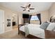 Bright bedroom with large window offering natural light, ceiling fan, and ensuite bathroom at 11980 Swansea Dr, Parker, CO 80134
