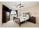 Cozy bedroom with a neutral color palette, plush carpet, a queen bed, dresser, and bright natural light at 11980 Swansea Dr, Parker, CO 80134