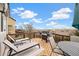 Outdoor deck features lounge chairs and outdoor furniture with expansive views on a sunny day at 11980 Swansea Dr, Parker, CO 80134