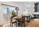 Dining area featuring a fireplace and sliding glass doors to the outdoor patio at 11980 Swansea Dr, Parker, CO 80134