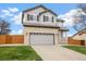 Charming two-story home with a brick and siding facade, attached garage, and well-maintained front lawn at 11980 Swansea Dr, Parker, CO 80134