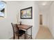 Cozy hallway nook with small desk, chair, and artwork, illuminated by natural light at 11980 Swansea Dr, Parker, CO 80134