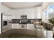 Bright kitchen features stainless appliances, granite counters, mosaic backsplash, and hardwood floors at 11980 Swansea Dr, Parker, CO 80134