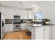Modern kitchen featuring white cabinets, stainless steel appliances, granite countertops and stylish backsplash at 11980 Swansea Dr, Parker, CO 80134