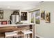 Finished basement kitchenette area featuring bar, stainless refrigerator, wine rack, and art at 11980 Swansea Dr, Parker, CO 80134