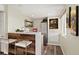 Finished basement kitchenette with bar seating, stainless steel refrigerator and modern design at 11980 Swansea Dr, Parker, CO 80134