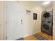 Laundry area with stacked washer and dryer set next to an exterior door at 11980 Swansea Dr, Parker, CO 80134