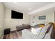 Basement living room with a sectional sofa, tv, and built-in shelving at 11980 Swansea Dr, Parker, CO 80134