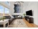 Bright living room with vaulted ceilings, hardwood floors, ample windows, modern furniture, and ceiling fan at 11980 Swansea Dr, Parker, CO 80134