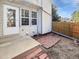 Cozy back patio with brick accents and a wooden fence, perfect for outdoor relaxation at 6852 S Dover Way, Littleton, CO 80128