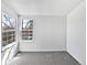 A naturally lit bedroom with neutral walls and carpet, with two large windows at 6852 S Dover Way, Littleton, CO 80128