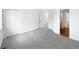 A bedroom featuring neutral walls and carpet, with a doorway to the bathroom visible at 6852 S Dover Way, Littleton, CO 80128